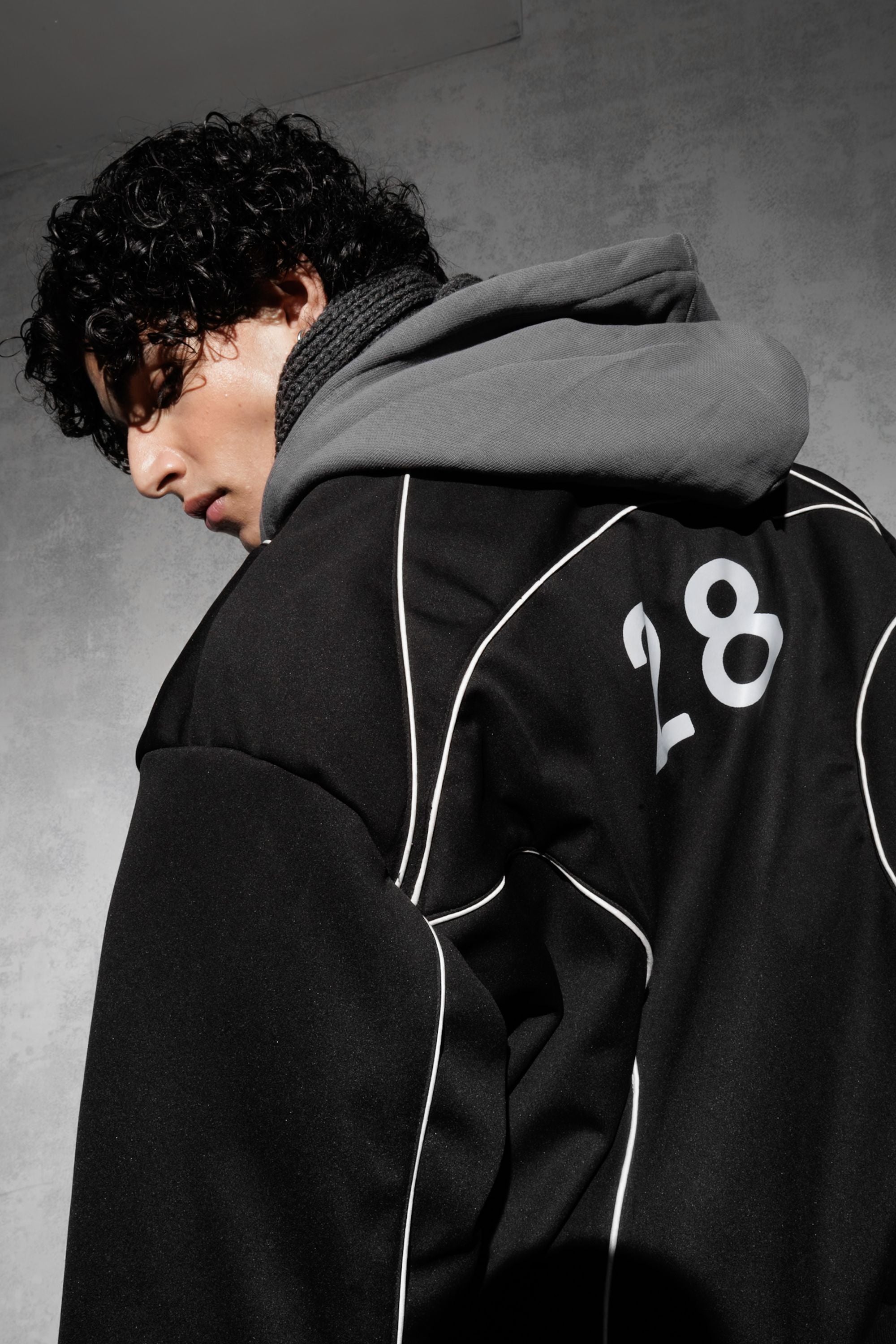 Close-up detail of black oversized cotton blend tracksuit hoodie