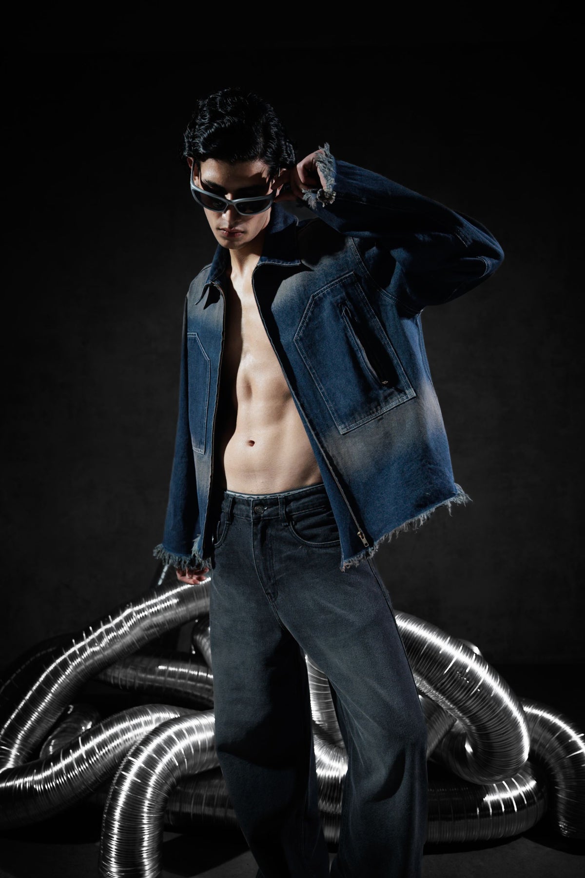 blue denim jacket with zipper closure and raw edge detailing in a casual fit