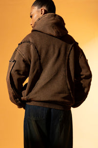 Brown cotton fleece hoodie with raw edges, designed for a laid-back fit and minimalistic style