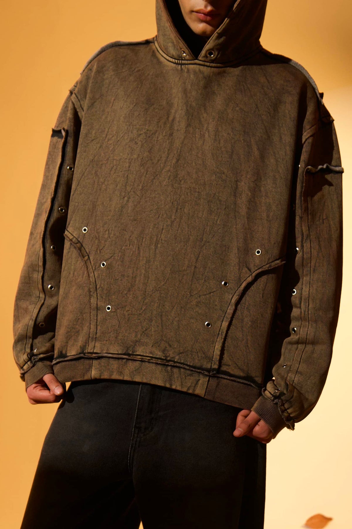 Brown cotton fleece hoodie with soft fleece texture and raw edges details, designed for everyday comfort 