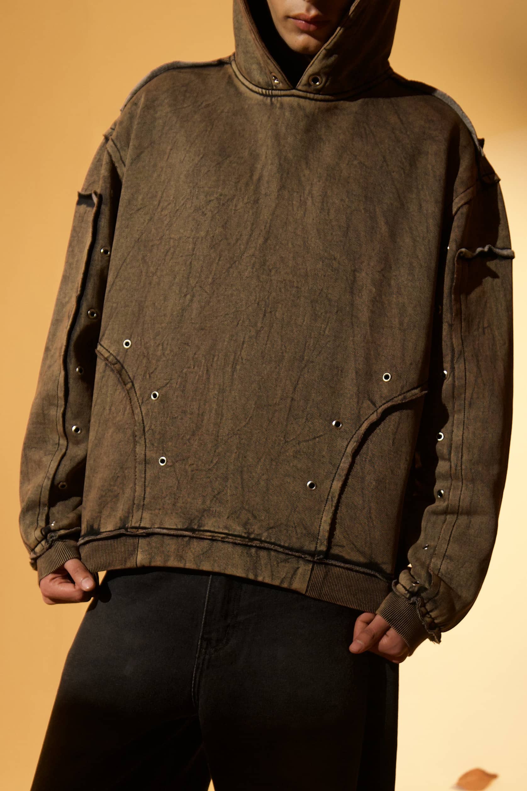 Brown cotton fleece hoodie with soft fleece texture and raw edges details, designed for everyday comfort 