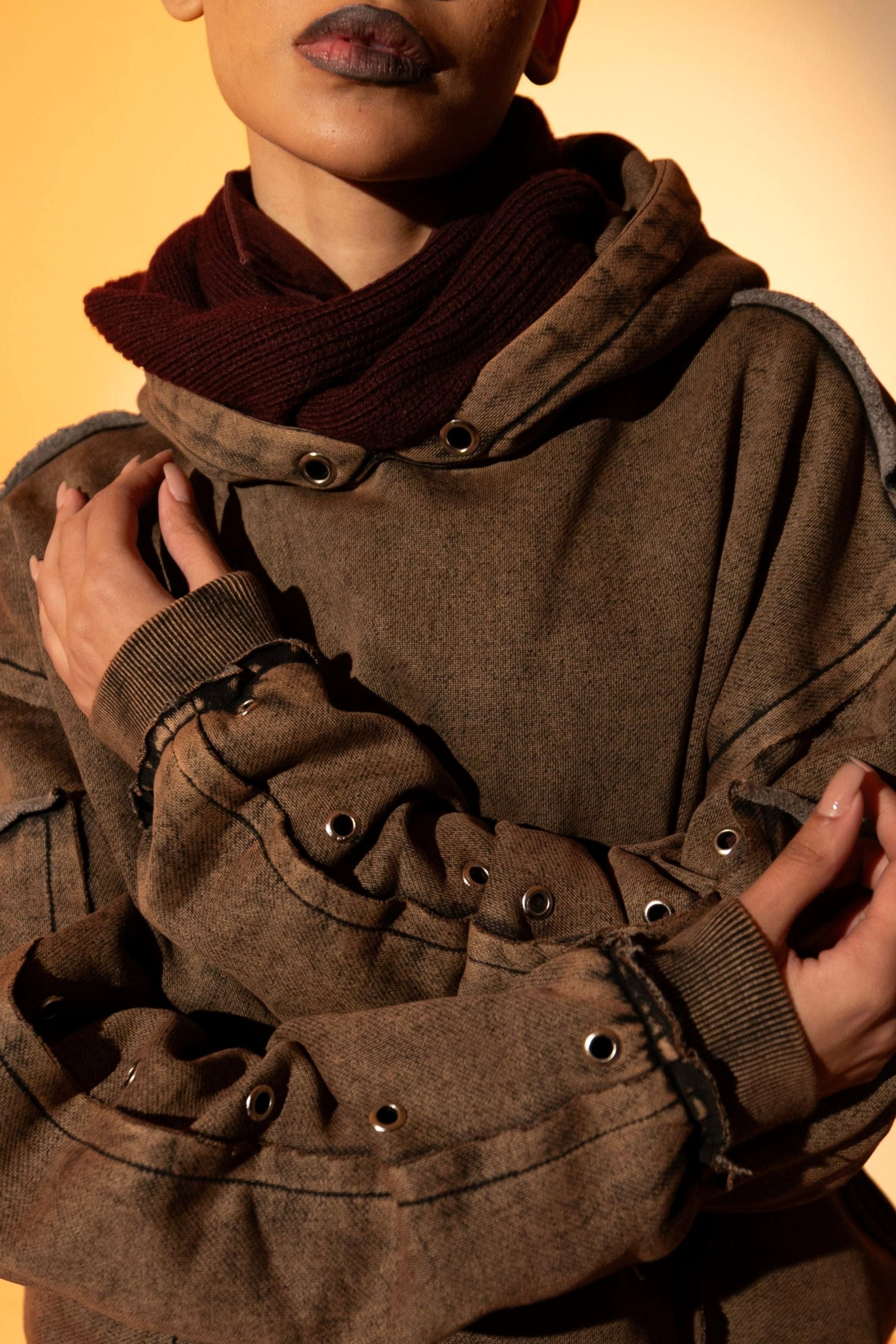 Brown cotton fleece hoodie with raw edge hem, designed for a comfortable, relaxed silhouette