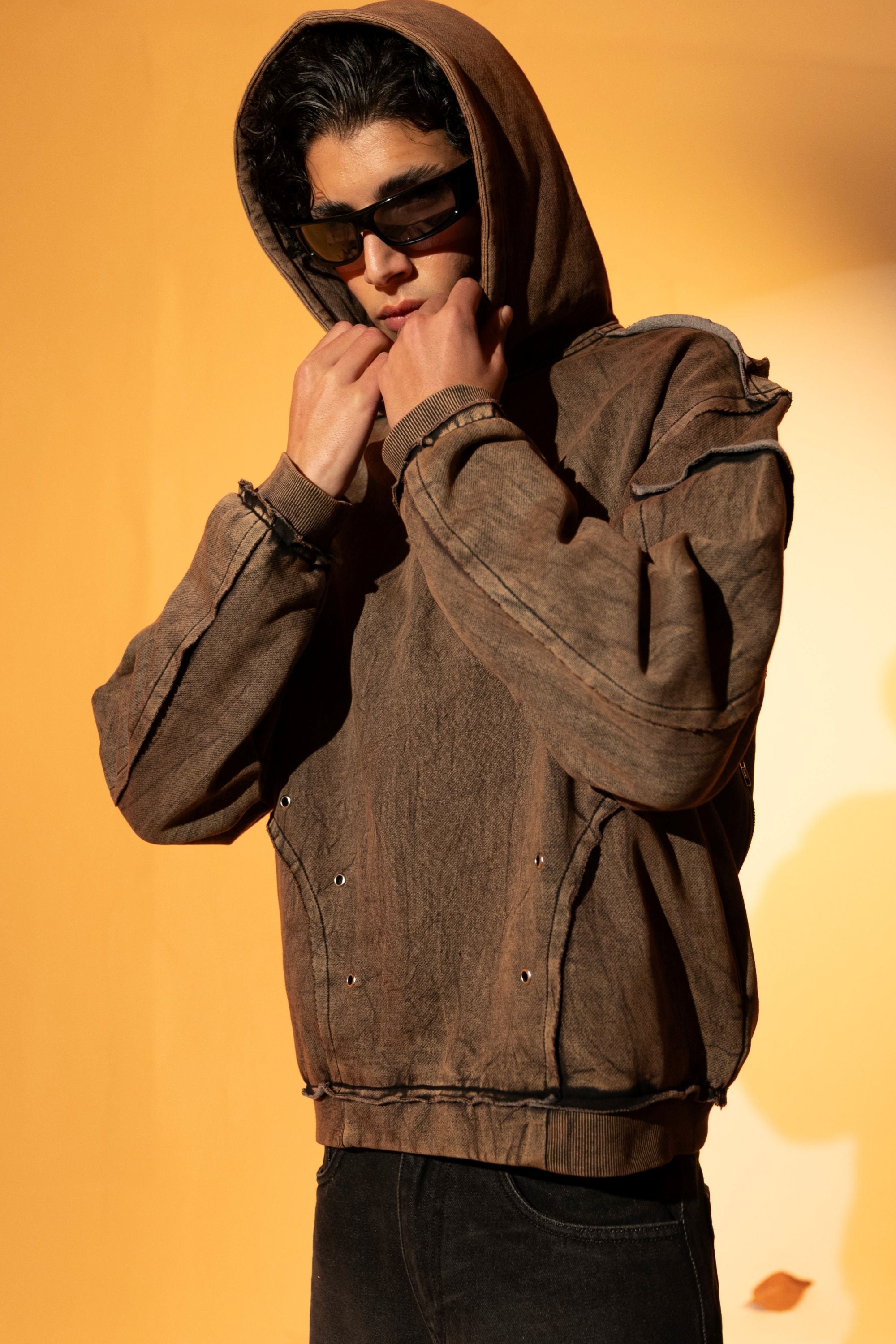 Oversized brown cotton fleece hoodie with unfinished hem detailing , adding an urban touch to the loose fit
