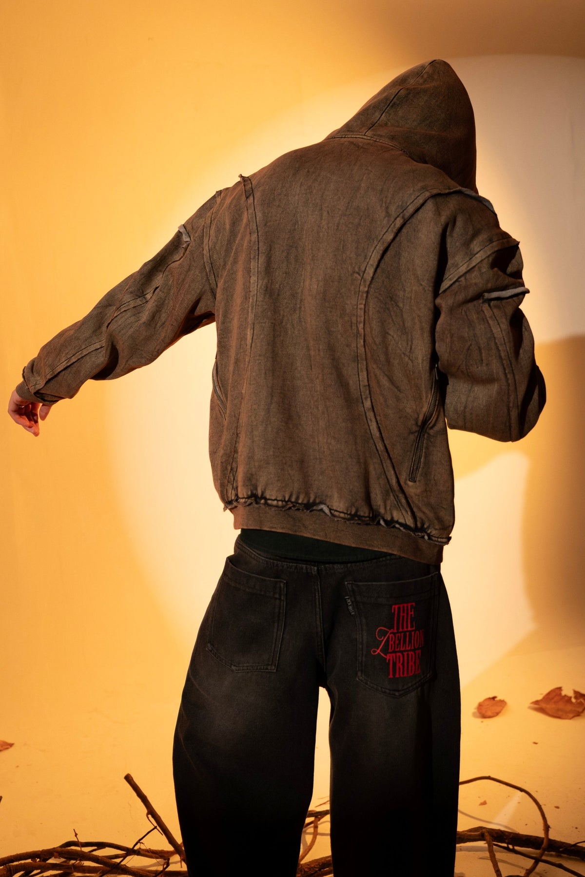 Brown cotton fleece hoodie with raw edge details, styled for easy layering in casual streetwear looks