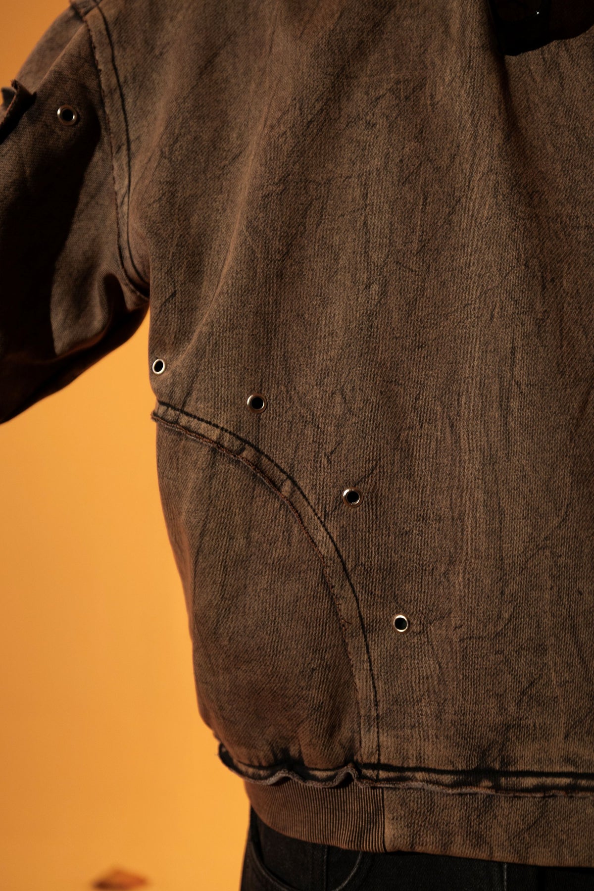 Brown cotton fleece hoodie with raw edge detailing, layered over comfortable streetwear pants
