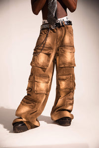 Relaxed fit brown denim cargo pants with a flowing streetwear silhouette and distressed textured finish.