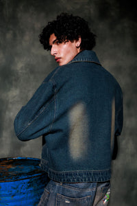 Denim jacket back panel showcasing distressed finish and reinforced stitching