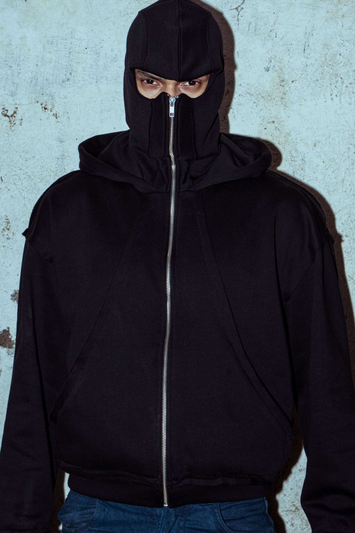 Black cotton hoodie with a relaxed fit, designed for streetwear