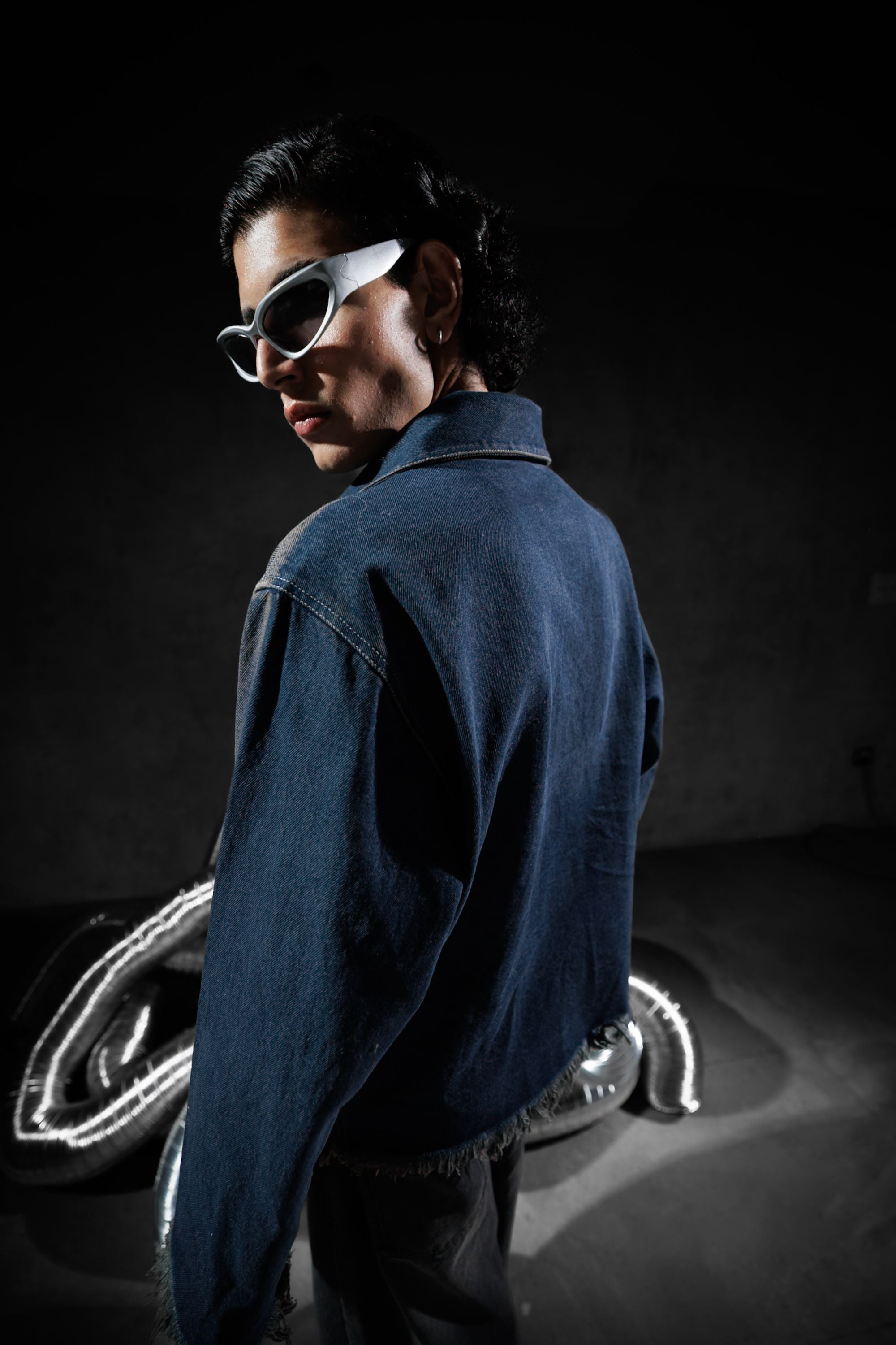 Back view of premium blue denim jacket with raw edges