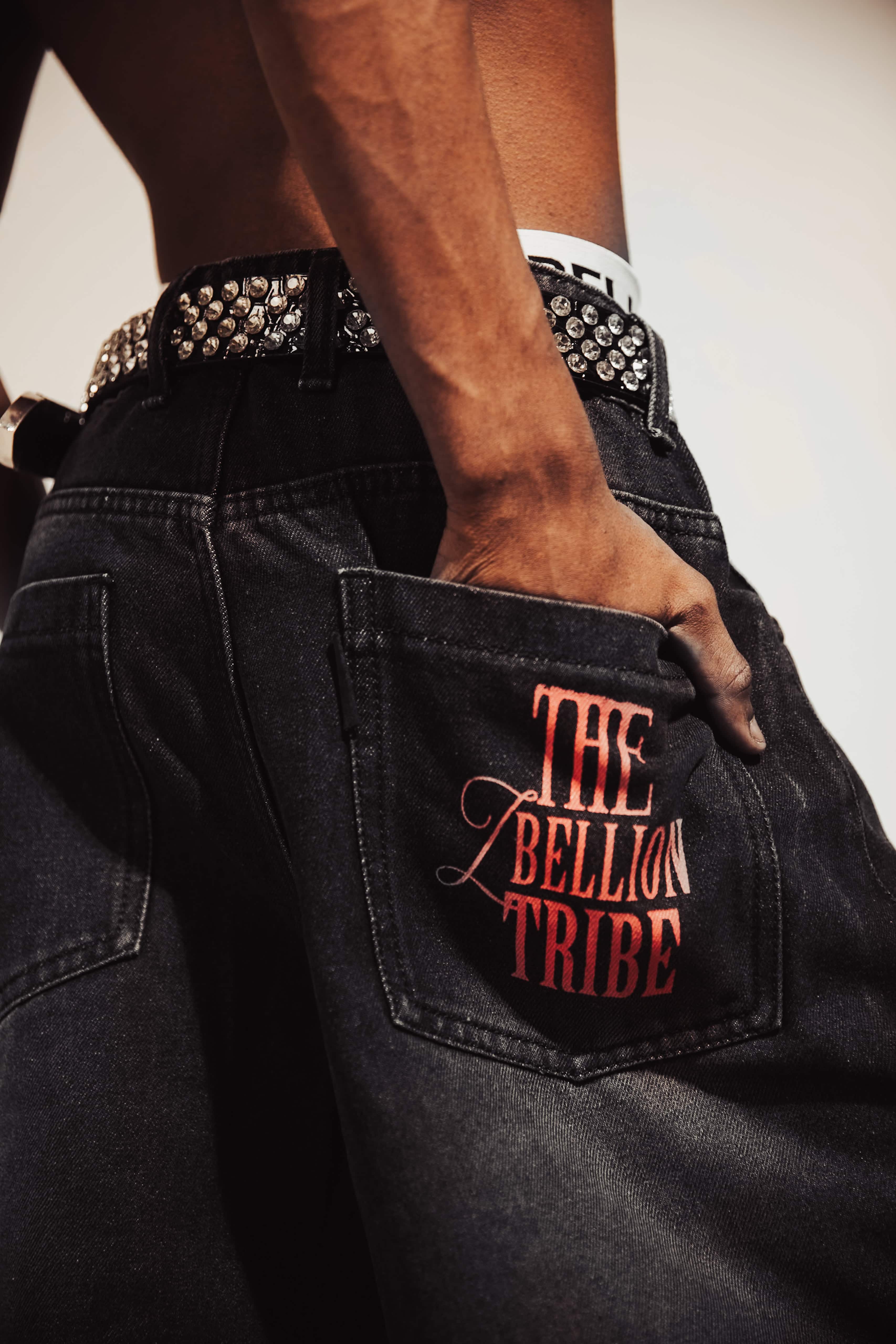 Baggy black denim jeans with textured detailing and bold distressed accents, designed for an impactful streetwear style