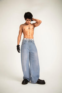 Jeans developed in denim with a textured minimal surface delivering depth and refined oversized proportions