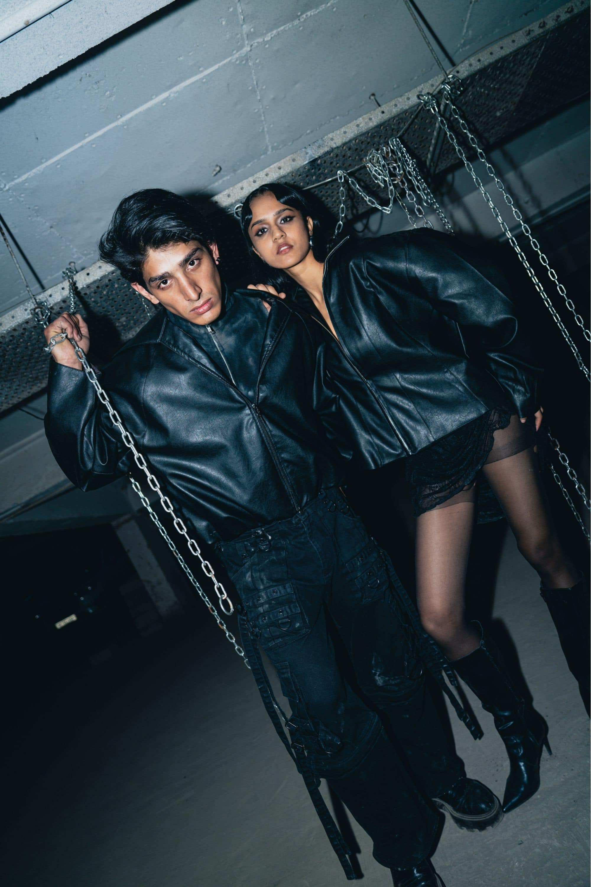 Bold print black leather biker jacket with textured finish, designed for a relaxed fit and street style