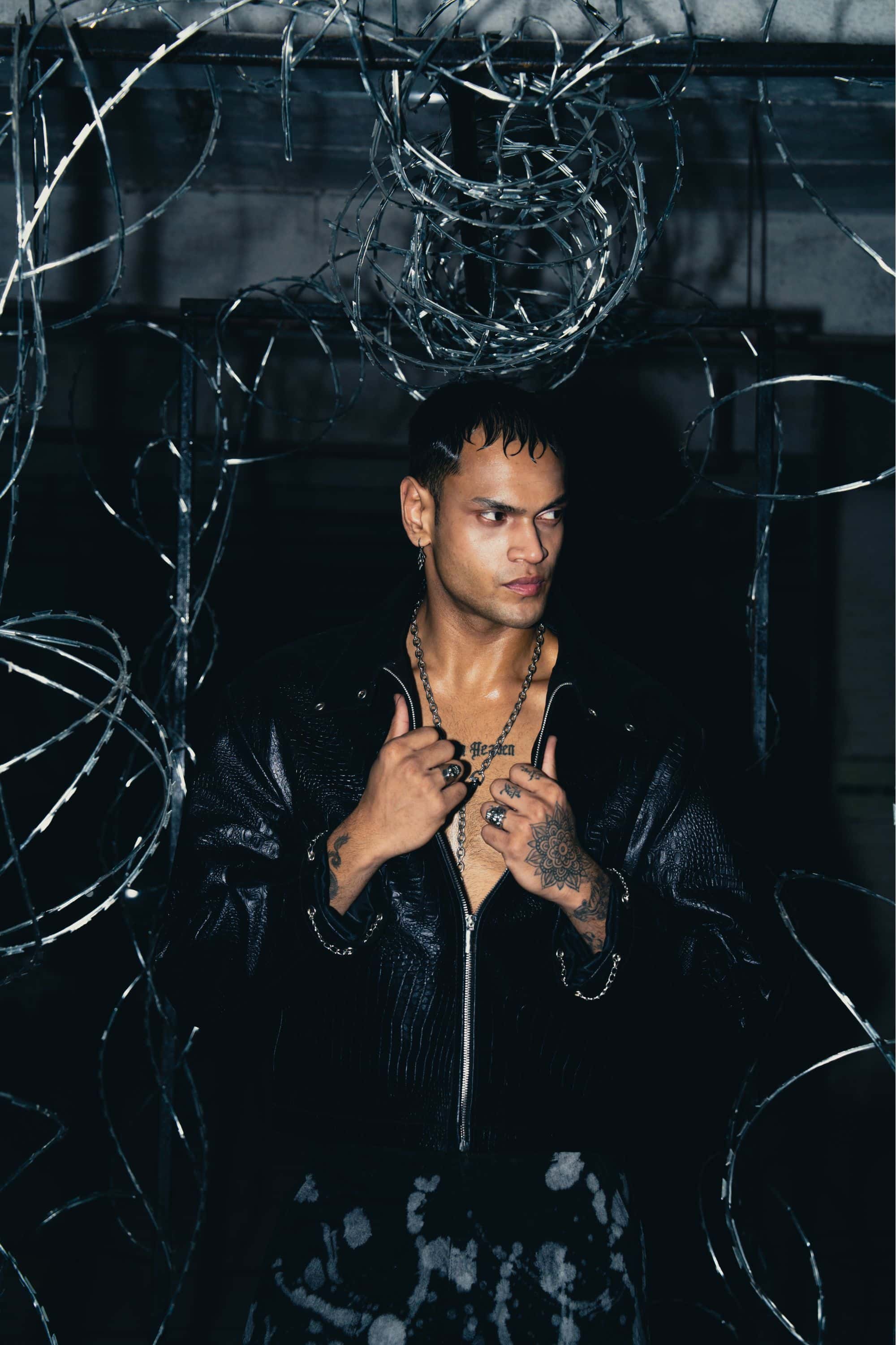 Distressed black jacket with bold detailing, perfect for an edgy street style