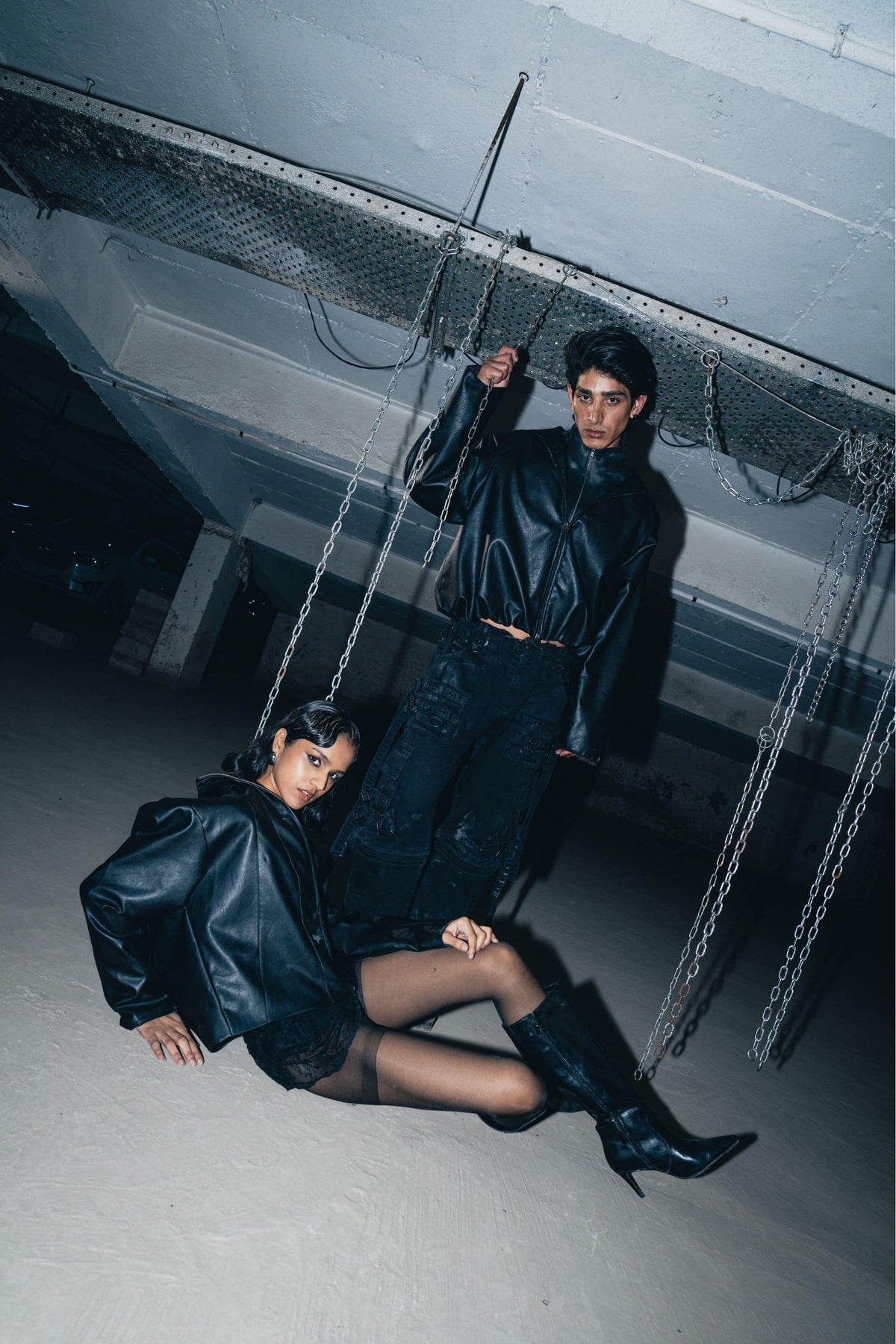 Embellished black leather biker jacket with intricate details, offering a relaxed fit and stylish finish