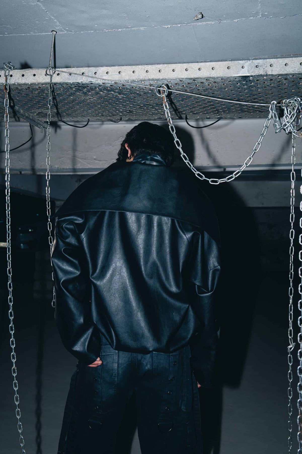 Luxury black leather biker jacket with minimalist design, offering a sleek and structured fit.