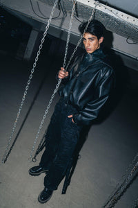 Sleek black leather biker jacket with a relaxed fit, designed for a comfortable yet stylish look