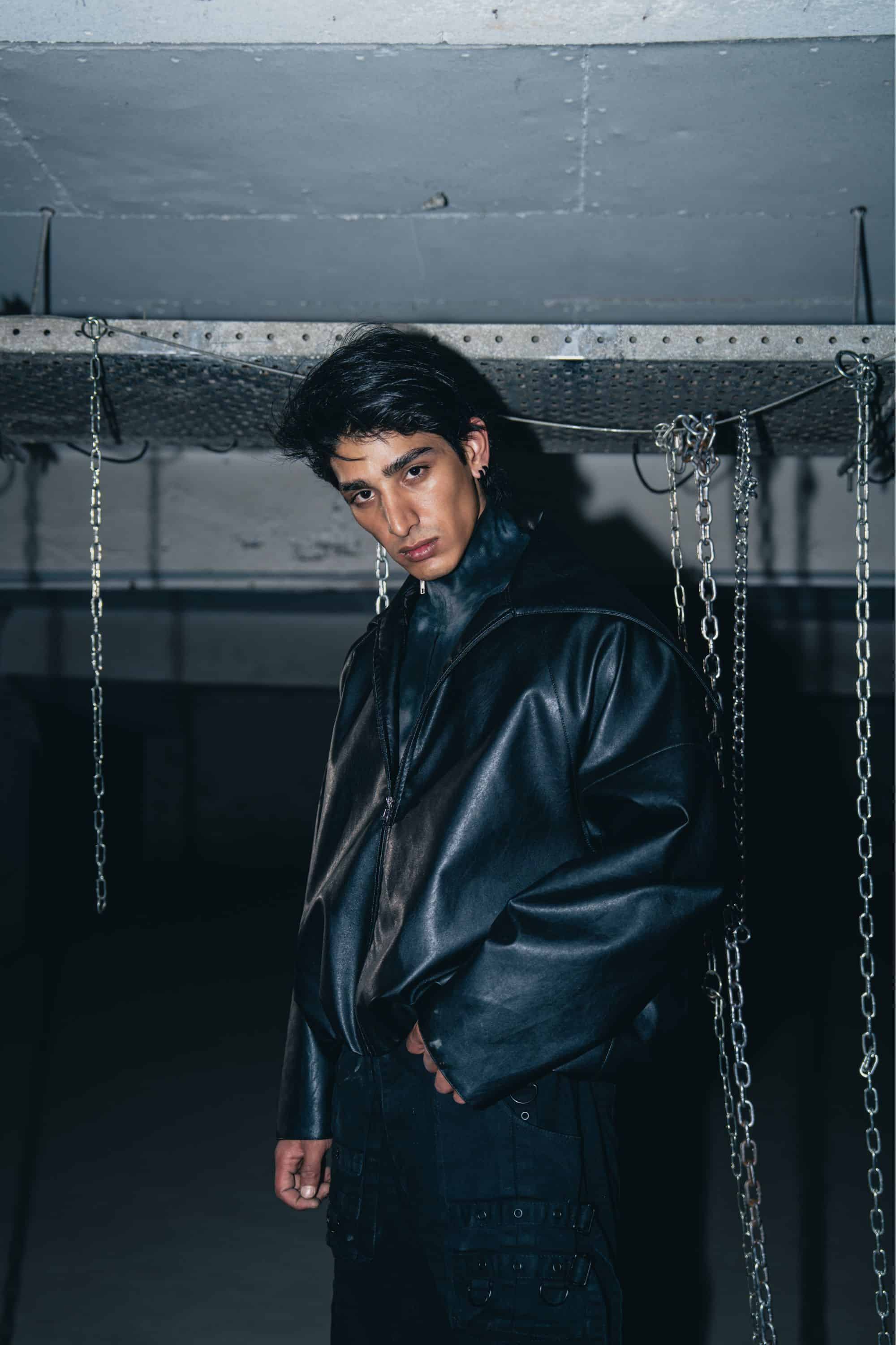 Structured black leather jacket in a minimalist biker style, designed for a sleek and comfortable fit