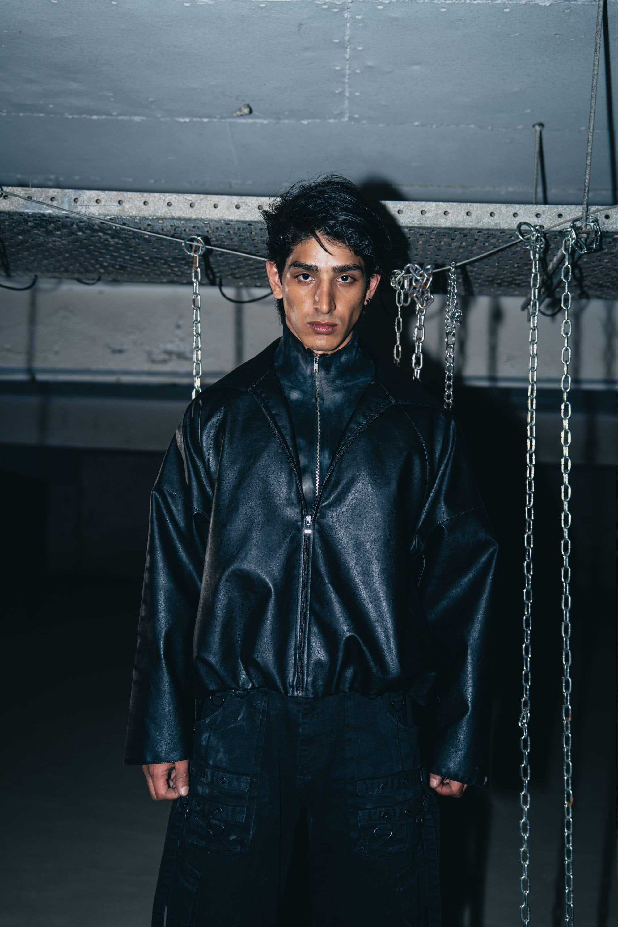 Structured black leather biker jacket with premium finish, designed for a tailored, high-end fit
