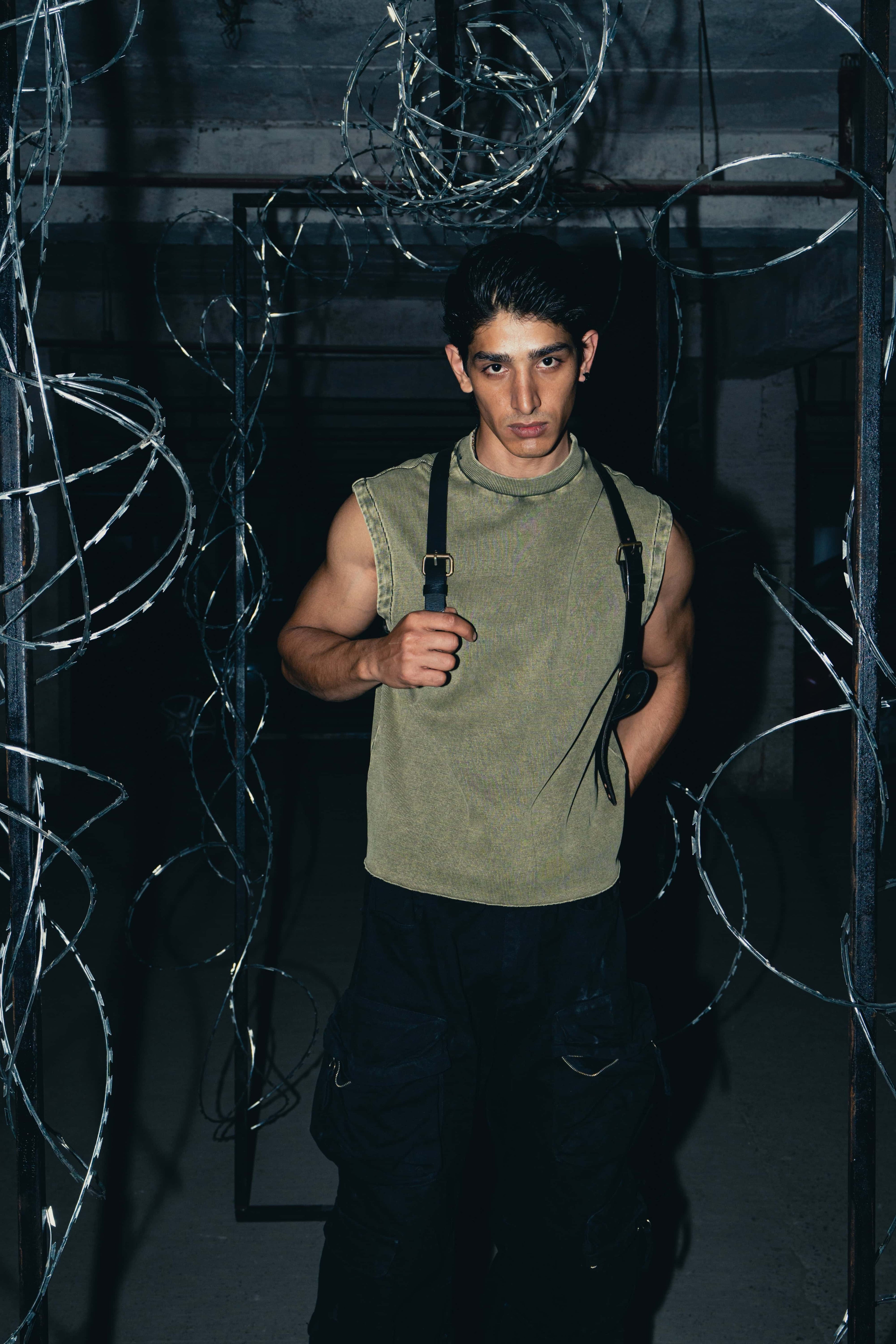 Olive green premium tank top with a streetwear-inspired grunge style, perfect for an edgy urban look