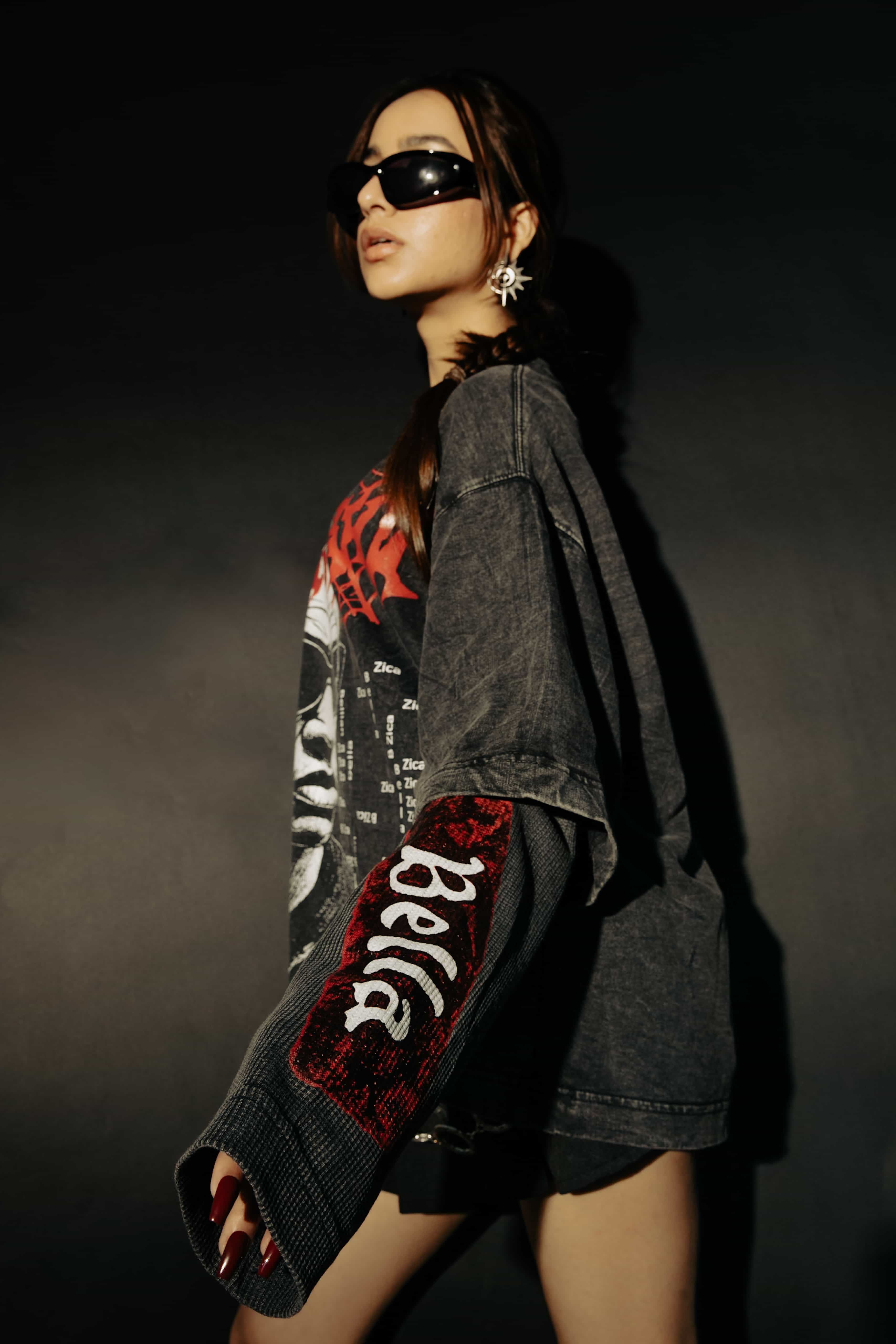 Close-up of bold graphic artwork on an oversized black cotton t-shirt