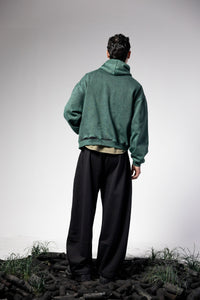 Oversized green hoodie highlighting full back design and relaxed streetwear fit