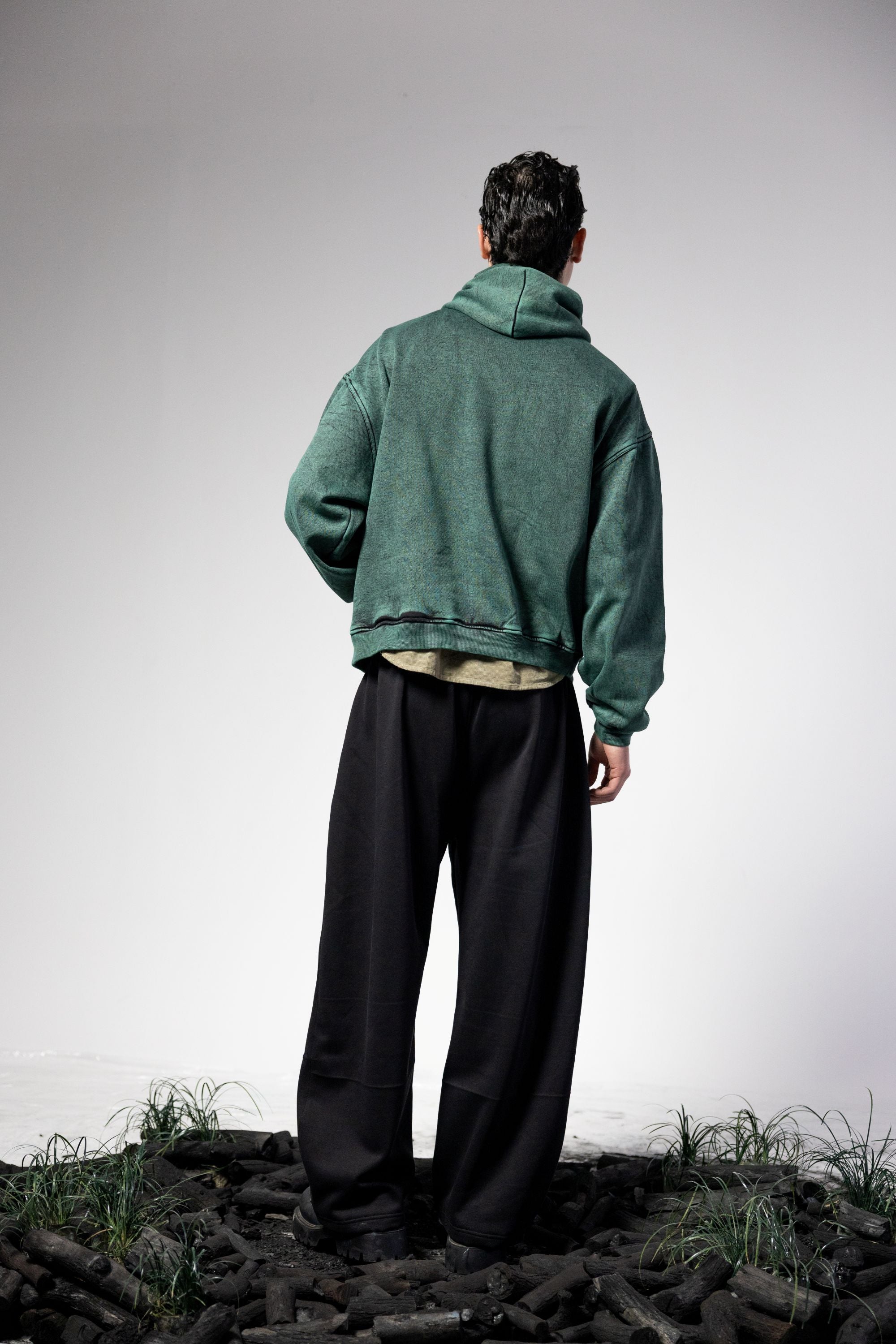 Oversized green hoodie highlighting full back design and relaxed streetwear fit