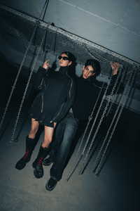 Black oversized shirt with a relaxed fit, crafted from eco-conscious materials, featuring modern double zip details for an urban, streetwear-inspired look