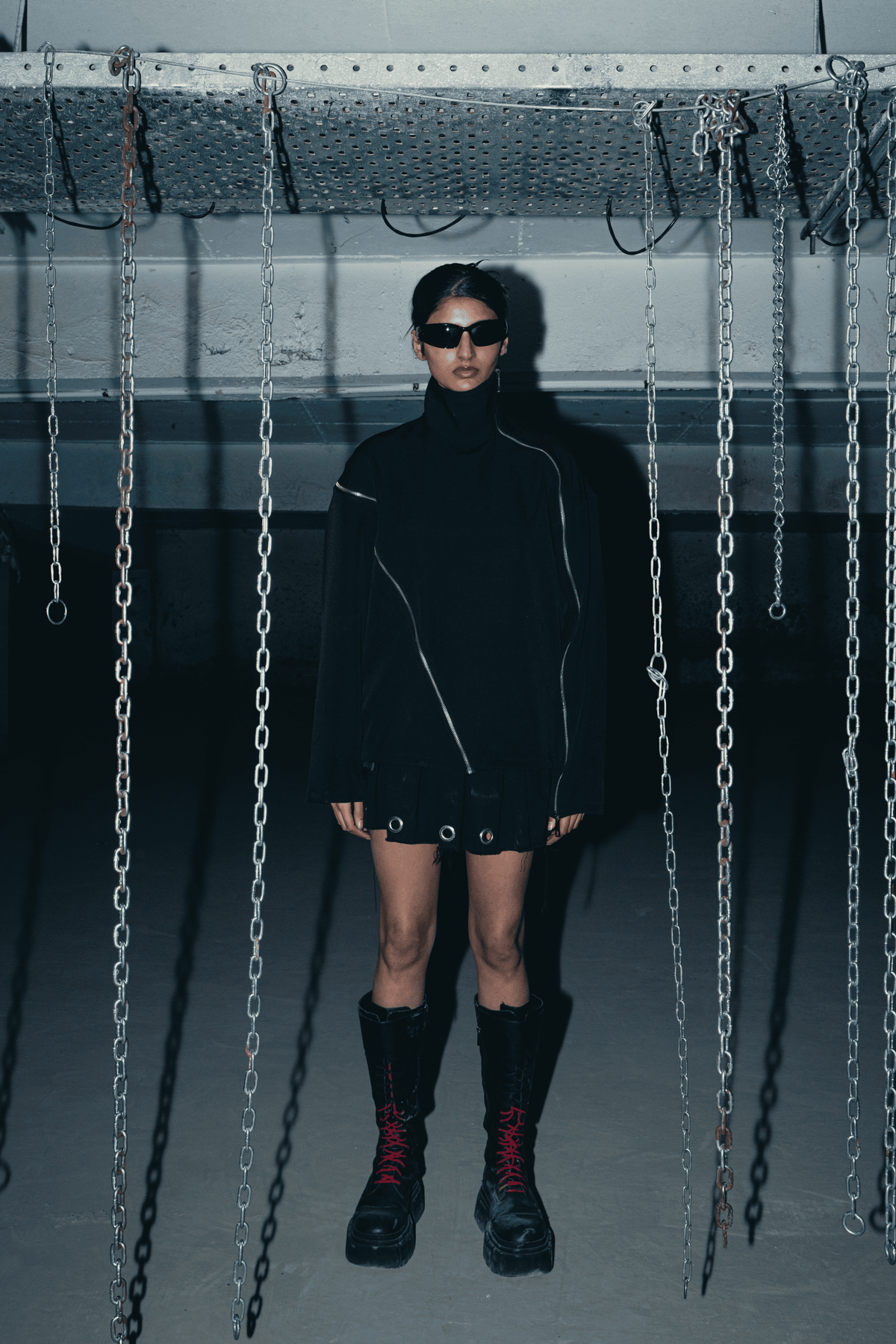 Black oversized shirt with a relaxed fit, featuring a modern design and double zip detail, made from sustainable materials