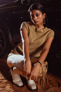 Minimalist beige tank top shot, focusing on clean lines and simple styling for modern men’s fashion