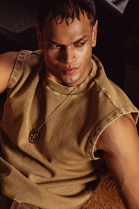 Beige tank top styled with cargo pants and accessories, urban streetwear look for men