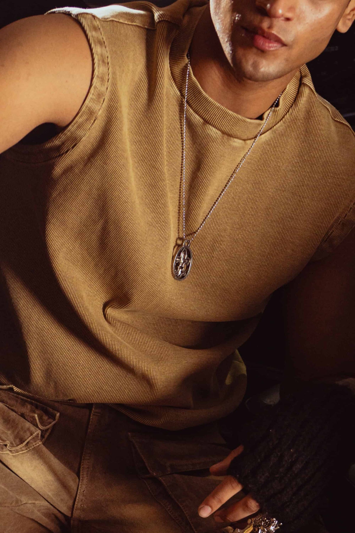 Beige tank top captured in dramatic lighting, highlighting urban vibe and premium design