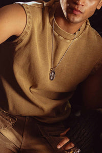 Beige tank top captured in dramatic lighting, highlighting urban vibe and premium design