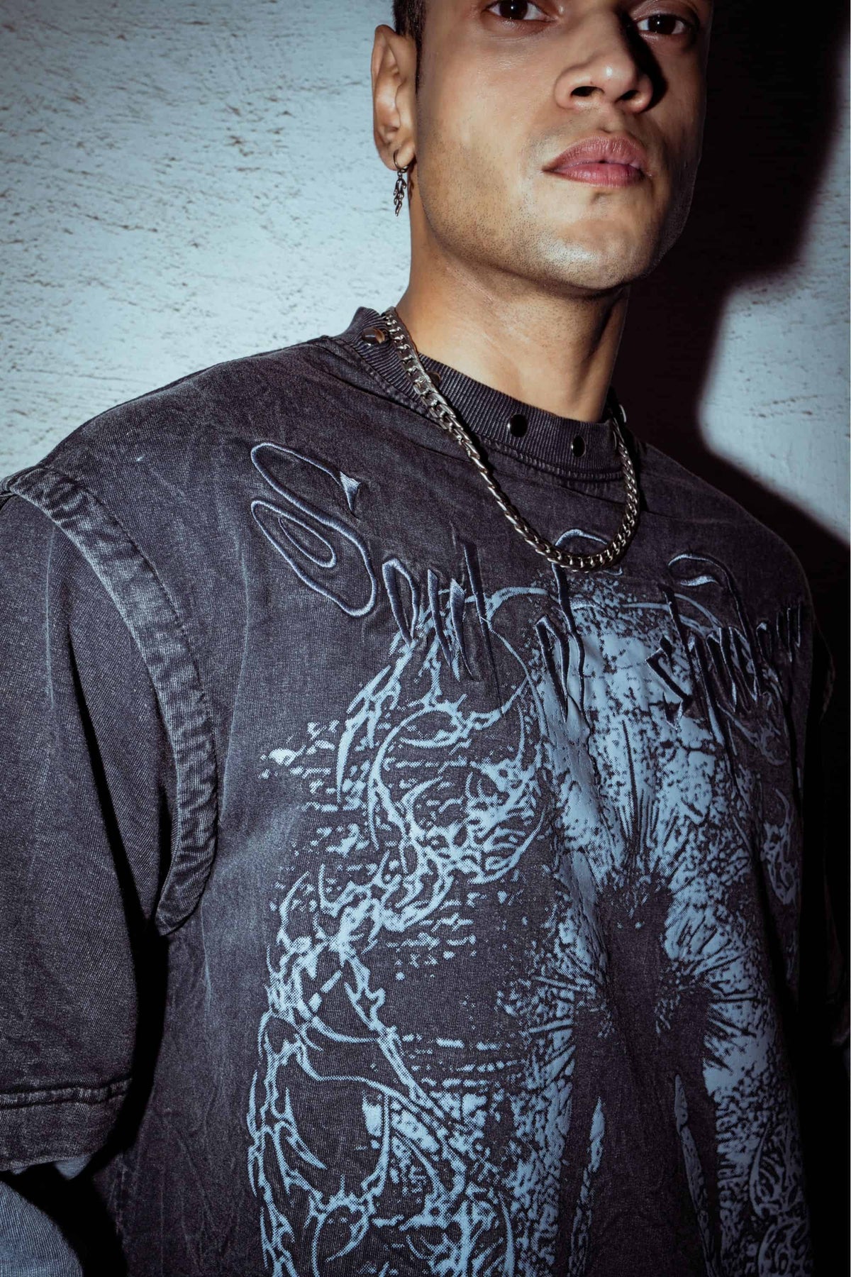 Combed cotton T-shirt with relaxed fit, featuring a detailed graphic print design in washed black for a contemporary streetwear look