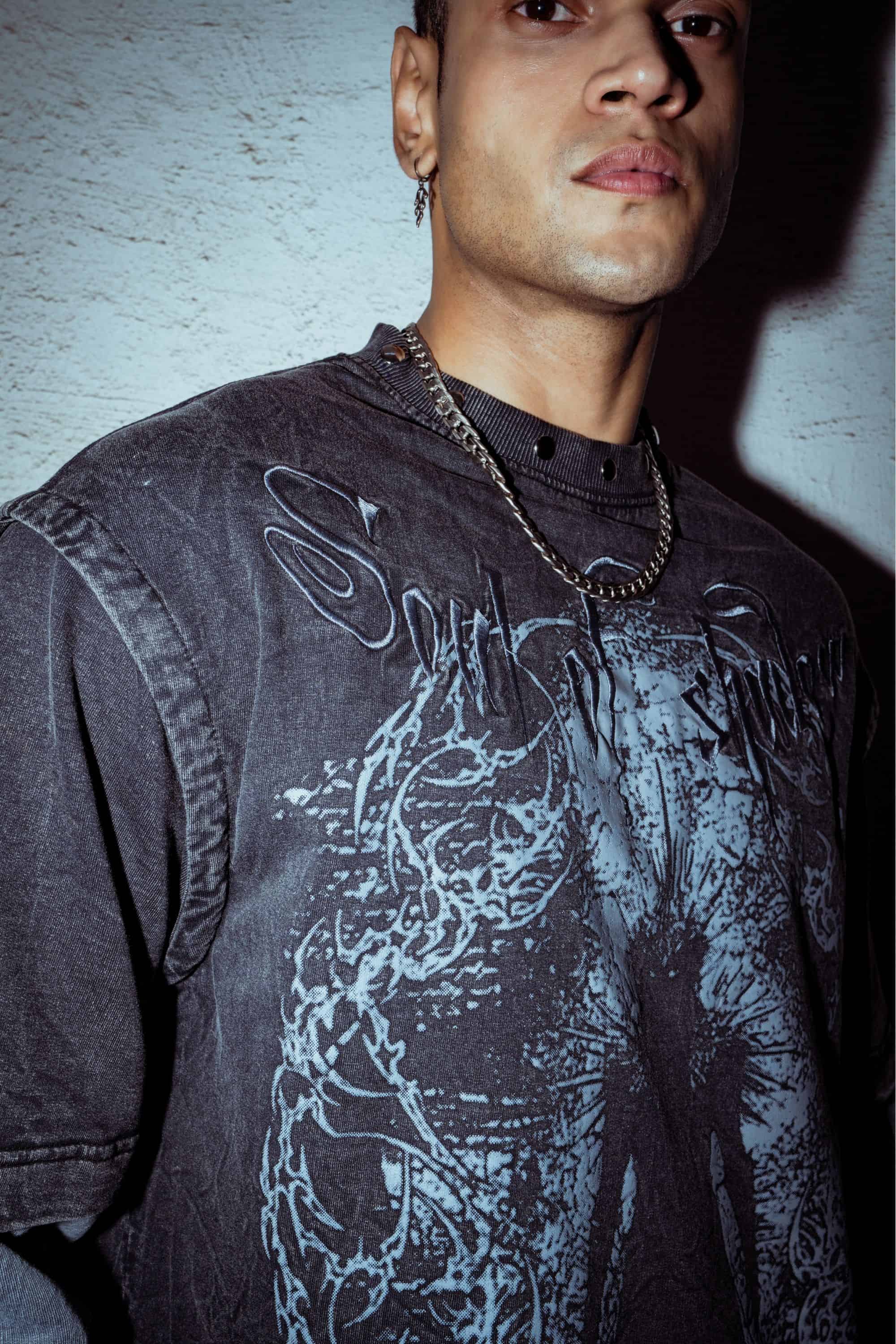 Combed cotton T-shirt with relaxed fit, featuring a detailed graphic print design in washed black for a contemporary streetwear look