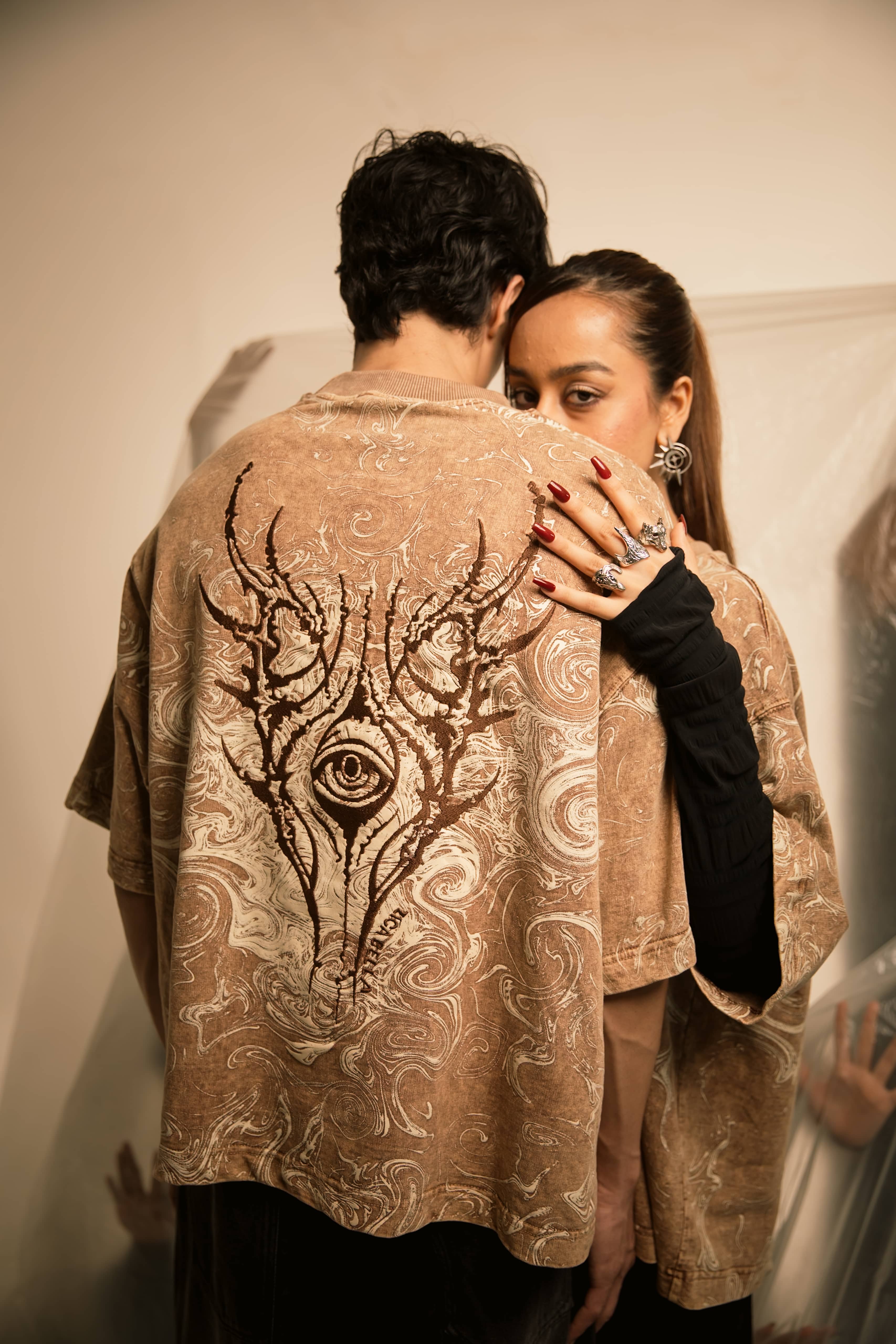 Symbolic embroidery on graphic streetwear t-shirt featuring abstract psychological horror detailing