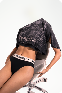 Acid wash black graphic t-shirt by Timelaps Coding displayed in an editorial pose with bold streetwear detailing by zica bella